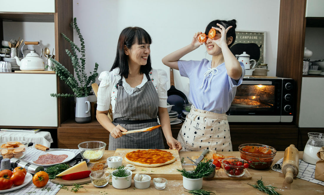 A photo of 2 people making a sweet potato pizza
